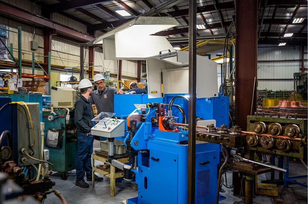 Operator running Ringmaster tube cutting machine for continuous high-volume ring production